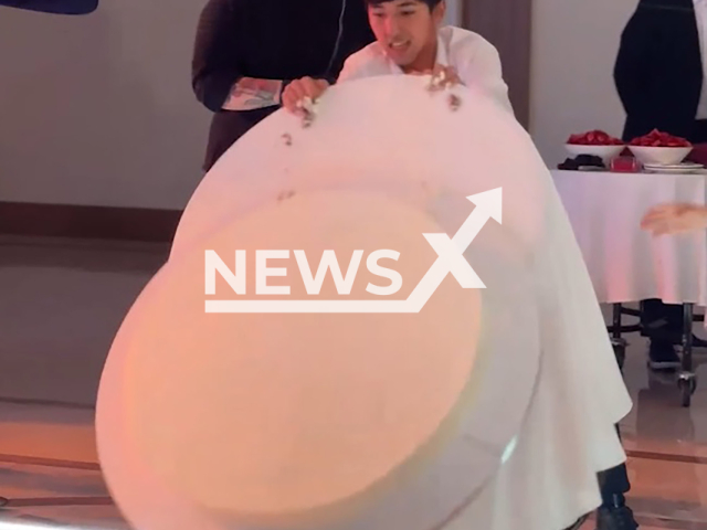 The waiter schoolboy Madiyar Aldabergenov pushes a cart with a cake, trips and drops the cake on the floor during a wedding in Borovoe, Kazakhstan on Saturday, Aug. 10, 2024. Luckily the cake was not damaged. Note: Photo is a screenshot from a video. (@martin_tips/Newsflash)