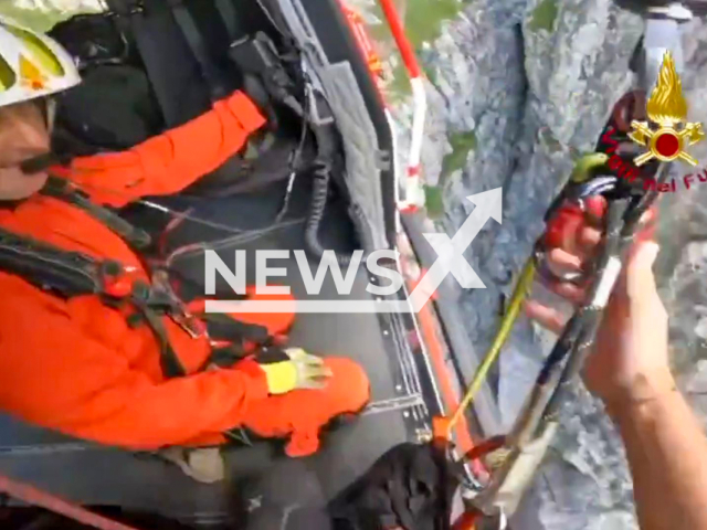 Rescuers save father and son from Lecco, Italy trapped in a gully on a route recommended for experienced climbers, undated. Note: Photo is screenshot from a video(@vigilidelfuoco/Newsflash)