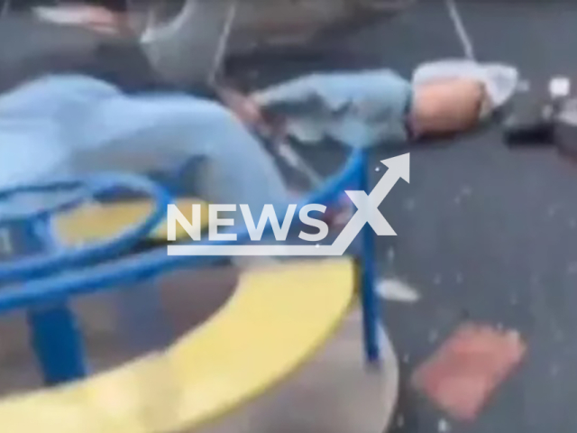 Teenagers spun a carousel with two schoolgirls on a playground using an electric scooter in Naberezhnye Chelny, the Republic of Tatarstan, Russia, undated. One of the girls flew out and hit the ground hard. Note: Photo is screenshot from a video(Newsflash)