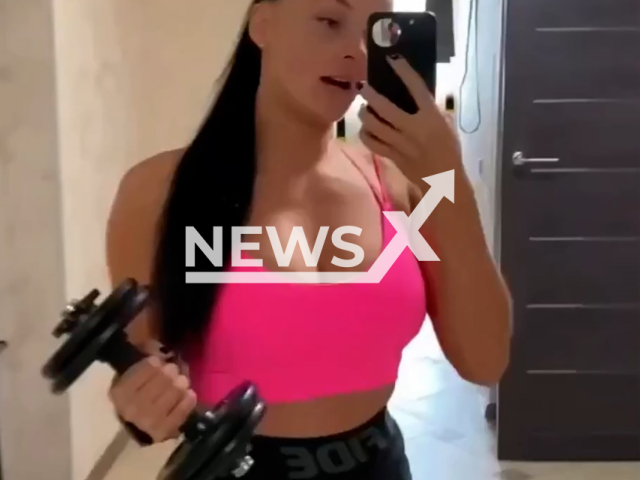 Viktoriya, 30, smashes her ex-husband's car with dumbbells and jumps on it after a quarrel in Novosibirsk, Russia, undated. They divorced after 14 years of marriage.  Note: Photo is a screenshot from a video. (Newsflash)