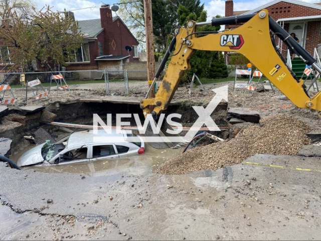 Sinkhole swallows entire car in Salt Lake City. Note: Police photo(Salt Lake City Police/Newsflash).