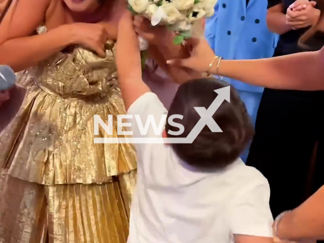 Goar Avetisyan's son Gaspar, 4, attacks the woman, almost tearing her dress off at the wedding of Goar's friends on Saturday, Aug. 24, 2024. He wanted to take away the bride's bouquet. Note: Photo is screenshot from a video (@goar_avetisyan/Newsflash)