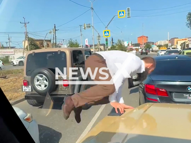 Blogger-auto-boor Said Shakhbanov jumps on a car and stunts on the road in Makhachkala, Dagestan, Russia, undated. He could face prison for this.
Note: Picture is screenshot from a video (Newsflash)