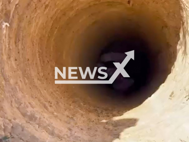 Rescuer is being fully lowered into a hole by the legs to save a fallen girl, 2, in Inderbor, Atyrau Region, southwest Kazakhstan on Sunday, Sep. 8, 2024. It was a three-meter (9,84 ft) hole. Note: Photo a is screenshot from a video(@qr_tjm/Newsflash)