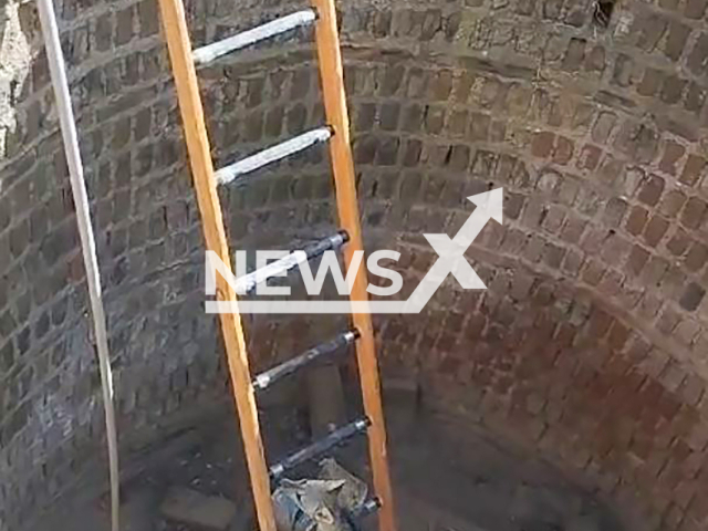 Firefighters lower ladder into deep well for trapped fox to climb out to safety in Limoeiro do Norte, Ceara State, Brazil, on Friday, September 6, 2024. The firefighters said that the animal had no apparent injuries. Note: Photo a is screenshot from a video(Military Fire Department of Ceara/Newsflash)