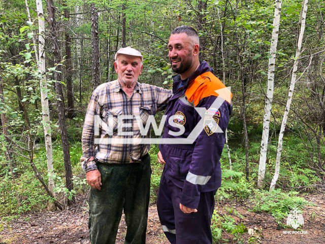 Photo shows a rescuer and a saved mushroom picker in Khabarovsk Krai, Russia on Wednesday, Sep. 18, 2024. A homeless dog sang along with rescuers' siren to help missing mushroom pickers find them after they got lost in the forest. Note: Licensed emergency photo. (@mchs_official/Newsflash)