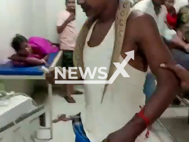 Video shows man with snake around his neck at hospital in Bhagalpur, India, Oct. 15, 2024. Prakash Mandal was bitten by a snake.Note: Photo is a screenshot from a video. (NF/newsX)