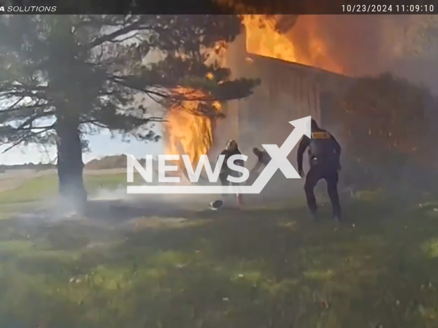 Firefighters rescue a 31-year-old woman trapped in the basement of a burning home in York Township, Medina County, Ohio in the United States on Wednesday, Oct. 23, 2024. 
Note: Photo is a screenshot from a video. (@medinacountysheriffoffice/NF/newsX)