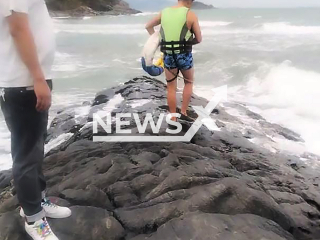 Man rescues elderly man from a sea in Guangdong, China, undated. The video was shared on Douyin - the Chinese version of TikTok on Nov. 3, 2024. Note: Photo a is screenshot from a video(AWR/newsX)