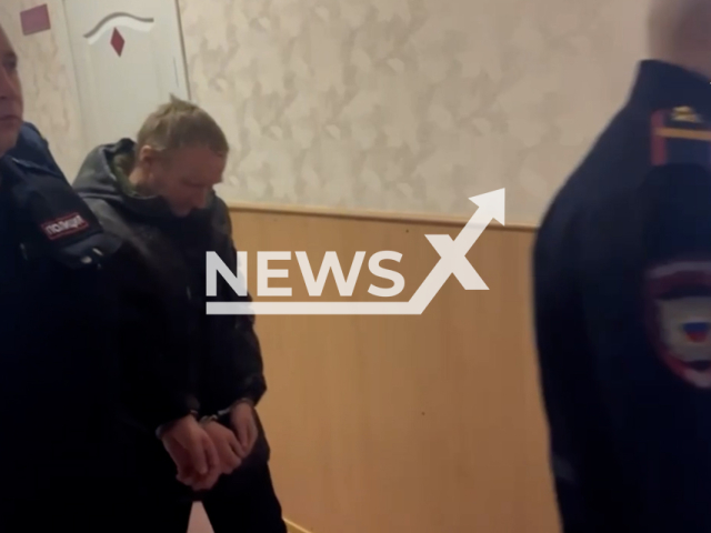 Footage shows detained Igor Zaika, 41, at the Uzhur District Court, Krasnoyarsk Krai, Russia on Thursday, Nov. 28, 2024. The suspect is the neighbor of Milena Shevelyova, 17, who was mauled by pigs. Note: Photo is a screenshot from a video. (@krksledkom, NF/newsX)