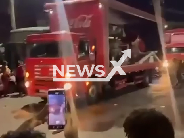 Residents boo and throw stones at the Coca-Cola Christmas Caravan in Salvador, Brazil, Monday, Dec. 9, 2024. The company ended the parade earlier for security reasons.   Note: Photo is a screenshot from a video. (NF/newsX)