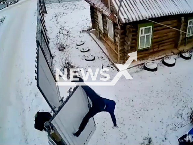 Romantic man Kurban can't open his beloved's gate and climbs over the fence in Yanaul, Republic of Bashkortostan, Russia on Sunday, Dec. 8, 2024. He gets his foot caught and hangs on the splits. Note: Photo is a screenshot from a video. (NF/newsX)