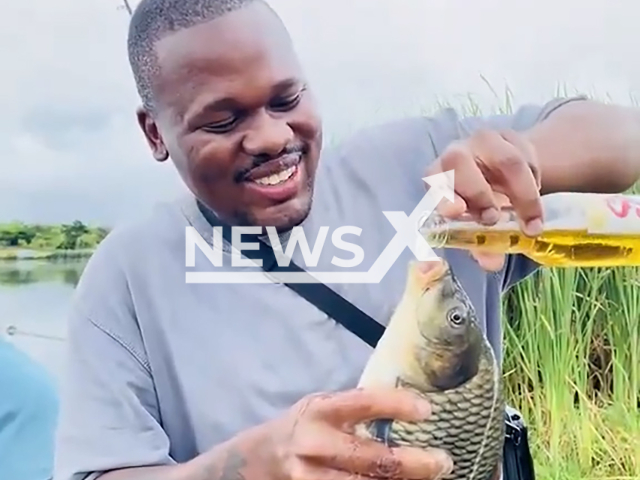 A man force-feeds fish with alcohol in South Africa, undated. He will be criminally prosecuted for the act. Note: Photo is a screenshot from a video. (NF/newsX)