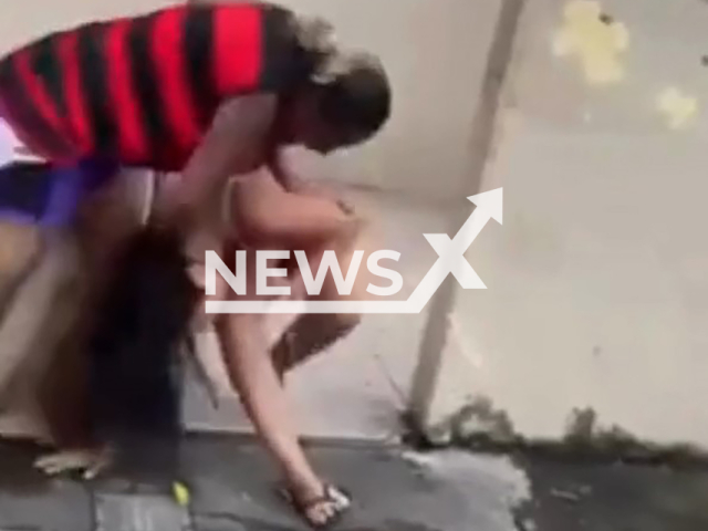 A woman beats another woman in Cubatao, Sao Paulo, Brazil, on Jan.27, 2025. The woman was reportedly furious after finding out she was her husband's lover. Note: Photo is a screenshot from a video. (Newsflash/NX)