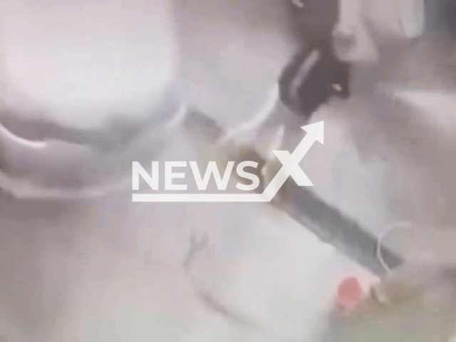 This image is a screen grab of the video supplied titled NewsX-ClumsyTurk-01.mp4: A man lost control of the hose when he turned on the pressurized water to wash her car in Bursa, Turkey undated. Video shared on Twitter (X) on Monday, Feb. 24, 2025.