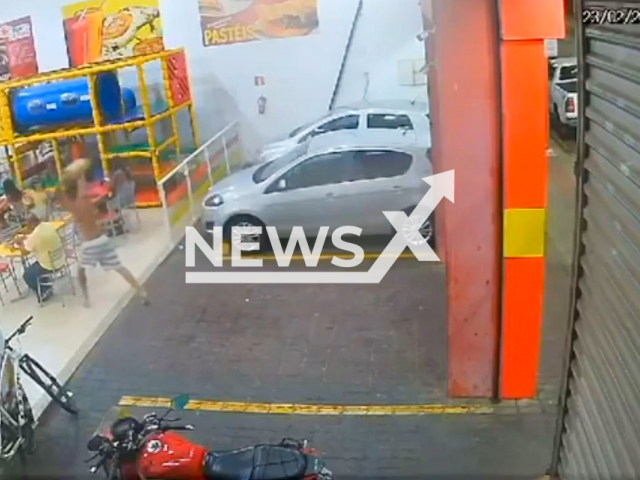 This image is a screen grab of the video supplied titled NewsX-YobSlem-01.mp4: The suspect hits another man on the head with an 8-kilogram piece of concrete while the victim is eating at a snack bar in Piracicaba, Brazil on Sunday, Feb. 23, 2025. (Clipzilla/NX)