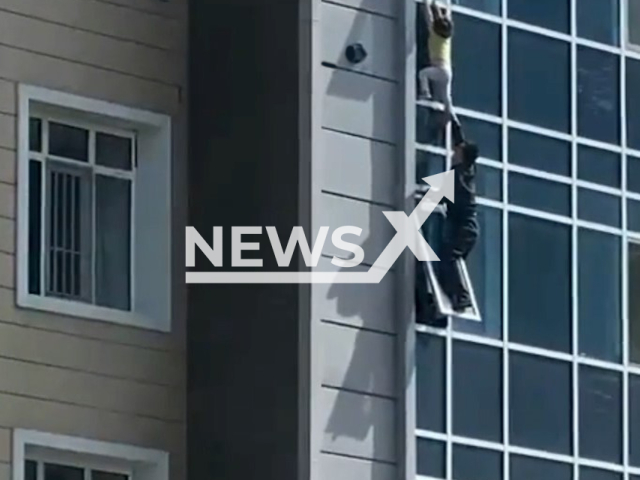 Sabit Shontakbaev, 37, rescued a three-year-old child from falling from the eighth floor in Nur-Sultan, Kazakhstan on 11th May 2022. Note: This picture is a screenshot from the video (Newsflash).