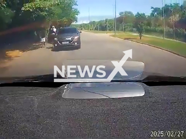 This image is a screen grab of the video supplied titled NewsX-Clipzilla/NX-01.mp4: Criminals attempted to steal a car near the Clementino Fraga Filho University Hospital on Ilha do Fundao, Brazil on the afternoon on Thursday, Feb. 27, 2025.(Clipzilla/NX)