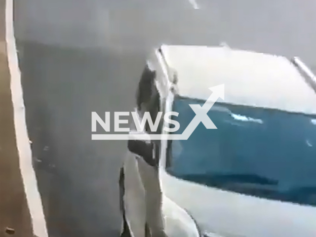 This image is a screen grab of the video supplied titled NewsX-OverloadedTruck-01.mp4: Truck overturns and topples over moving motorbike in Rajasthan’s Dholpur district, India, Feb. 25, 2025.(	Clipzilla/NX)