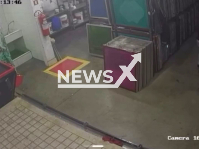 This image is a screen grab of the video supplied titled NewsX-PoisWom-01.mp4: Security camera footage shows the moment when the suspect enters a restricted access area of ​​the company, puts a substance in the victim's thermos and takes her own bottle that was next to it in Greater Goiania, Brazil on Thursday, Feb. 13, 2025.(Clipzilla/NX)