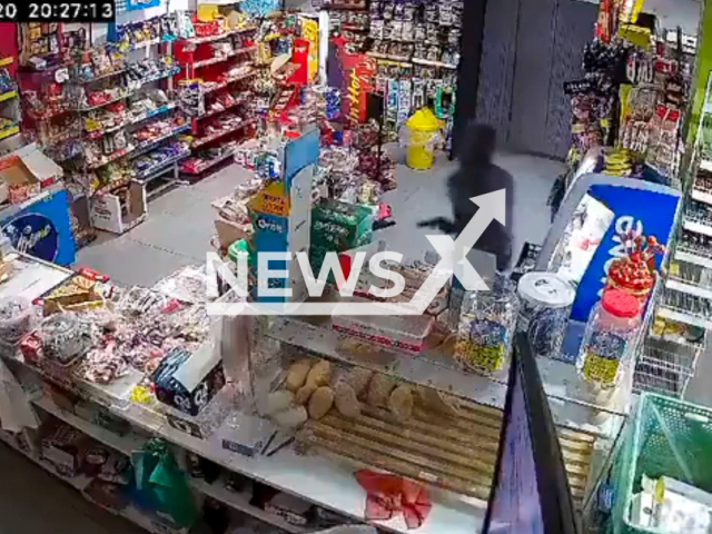 This image is a screen grab of the video supplied titled NewsX-StireLedy-01.mp4: A Spanish lady confronts and chases an armed robber until she gets him to flee from the store in Lepe, Huelva, Spain, on Thursday, Feb. 20, 2025.