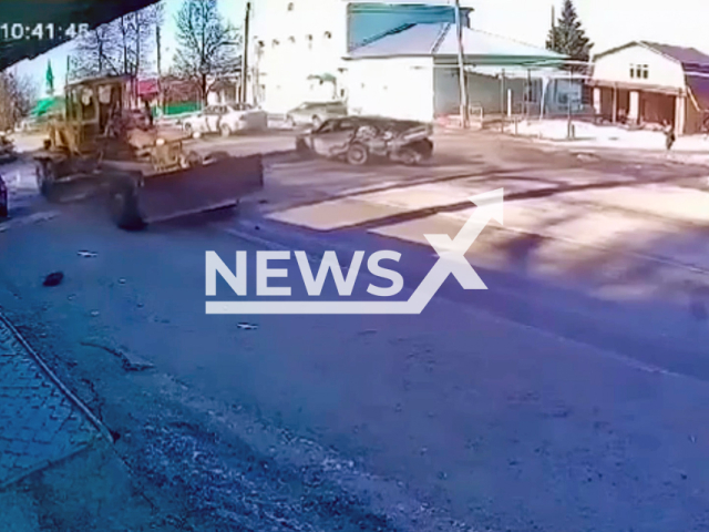 CCTV footage shows a Hyundai Sonata unable to react skids and crashes into DZ -120 construction grader on Proletarskaya Street in the village of Kalinino, Kirov Region, Russia on Monday, Mar. 17, 2025. Note: Photo is a screenshot from a video. (Clipzilla/NX)