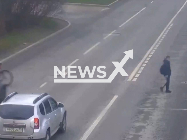 This image is a screen grab of the video supplied titled NewsX-GroceryCough-01.mp4: CCTV footage shows a cyclist being struck by a UAZ Patriot that ran a red light in Cherepovets, Russia on Thursday, Apr. 24, 2025.(Clipzilla/NX)