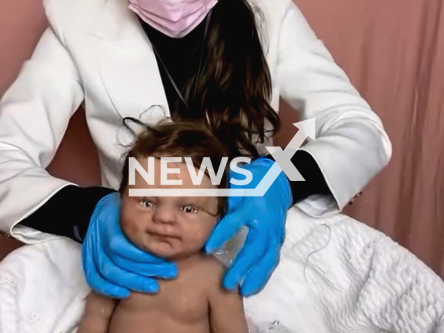 Brazilian influencer Carolina Rossi simulates the birth of a reborn baby, undated. The video was initially published in 2022.Note: Photo is a screenshot from a video. (@carolinarossi10/Newsflash/NX)