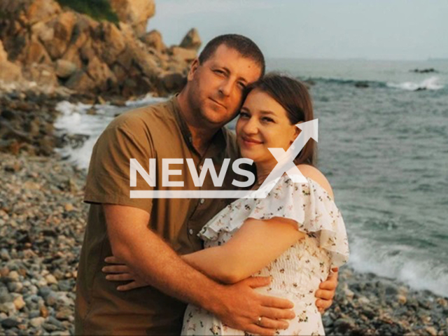 Olga Guzikova, 34, poses with husband in undated photo. Doctors broke her baby's shoulder during childbirth and it later died in Blagoveshchensk, Russia. Note: Private photo taken from local media. (Newsflash/NX)