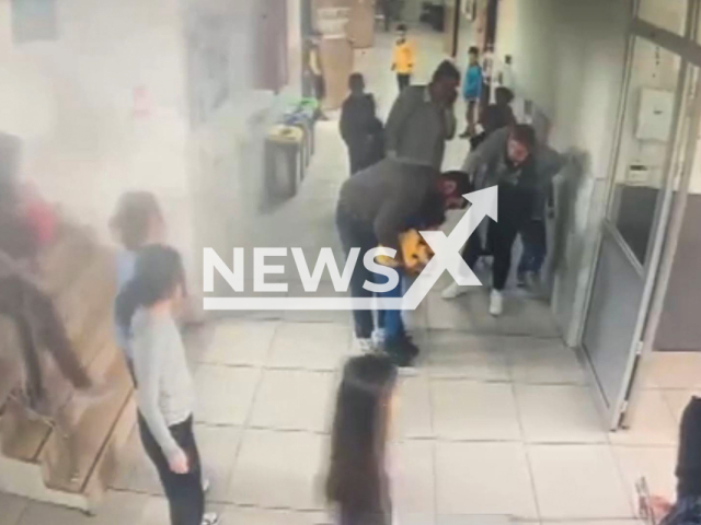 This image is a screen grab of the video supplied titled NewsX-ChokingStudent-01.mp4: CCTV shows a teacher saving a student from choking with a quick Heimlich maneuver in Kaynarca, Sakarya, Turkey on Wednesday, Apr. 30, 2025.(Clipzilla/NX)