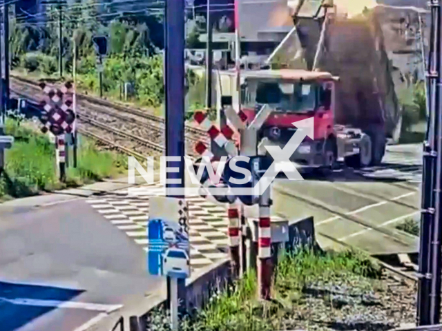 Truck overturns after hitting overhead wires at railway in Groot-Bijgaarden, Belgium, April 30, 2025. The driver had left the loading platform up. Note: Photo is a screenshot from a video. (Infrabel/Newsflash/NX)