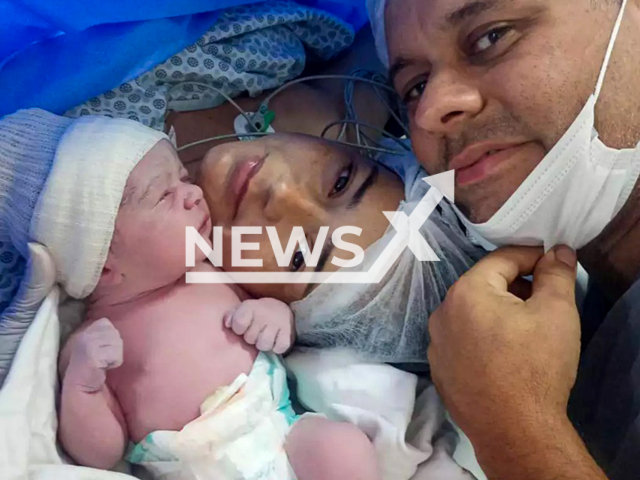 Picture shows Amanda Porfirio da Silva, 33, her husband Thiago Jusis with their newborn, undated. She died after giving birth in Santos, Brazil. Note: Private photo taken from local media. (Newsflash/NX)
