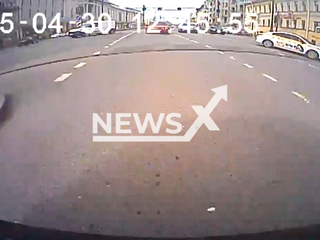 This image is a screen grab of the video supplied titled NewsX-UnicycleColl-01.mp4: Dash cam shows a unicycle rider colliding with a car and being thrown onto the street in Saint Petersburg, Russia on Wednesday, Apr. 30, 2025. (Clipzilla/NX)