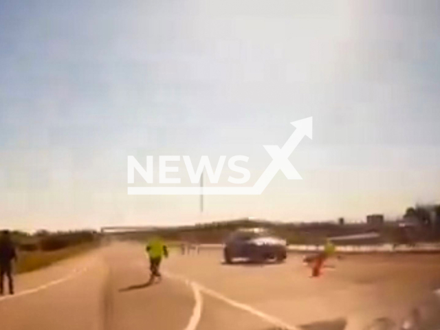 This image is a screen grab of the video supplied titled NewsX-JeepHit-01.mp4: CCTV shows a Jeep speeding through a police checkpoint, hitting an officer in Tekirdag, Turkey on Sunday, May 4, 2025.(Clipzilla/NX)
