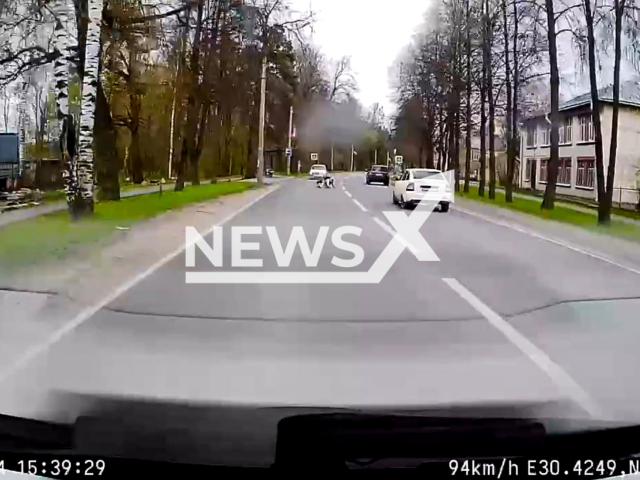 This image is a screen grab of the video supplied titled NewsX-UnicycleFall-01.mp4: Dashcam footage captures the moment a unicycle rider loses balance and falls onto the road, landing in front of an oncoming car in Saint Petersburg, Russia, on Sunday, May 4, 2025.(Clipzilla/NX)