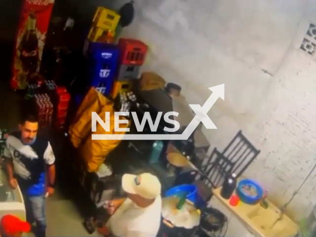 This image is a screen grab of the video supplied titled NewsX-DrunRules-01.mp4: CCTV footage shows a man during a game of Russian roulette pulling the trigger on a loaded revolver pointed at his head, resulting in a fatal shot in Conchal,  Sao Paulo, Brazil on Saturday, May 3, 2025. (Clipzilla/NX)