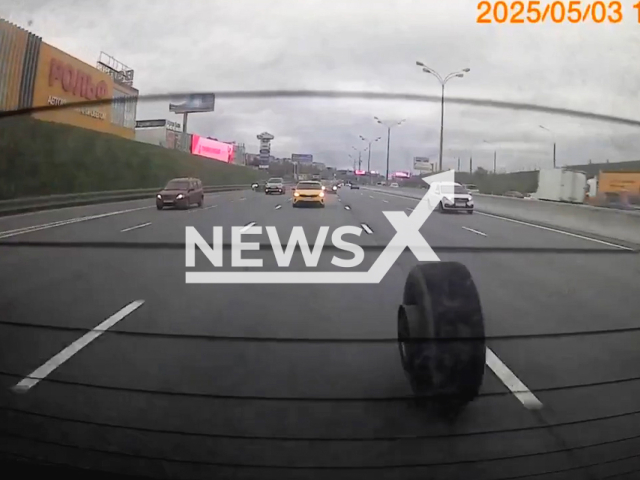 This image is a screen grab of the video supplied titled NewsX-RearTire-01.mp4: Dashcam footage captures when a truck loses its rear tire, but the driver continues driving, seemingly unaware of the incident on the MKAD in Moscow, Russia on Saturday, May 3, 2025.(Clipzilla/NX)