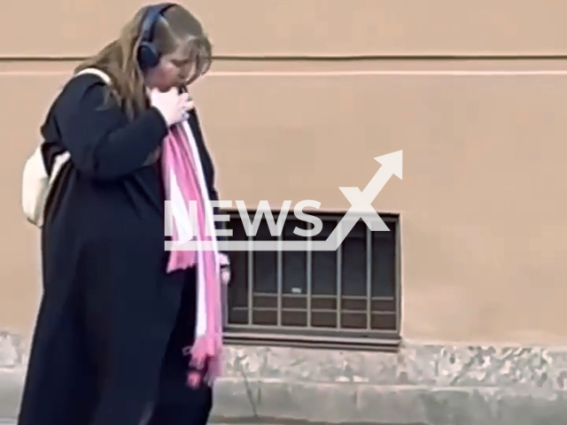 This image is a screen grab of the video supplied titled NewsX-PetPigeon-01.mp4: Footage shows a woman walking her pet pigeon on a leash in the streets of Saint Petersburg, Russia, undated. Footage shared on social media on Wednesday, Apr. 30, 2025.