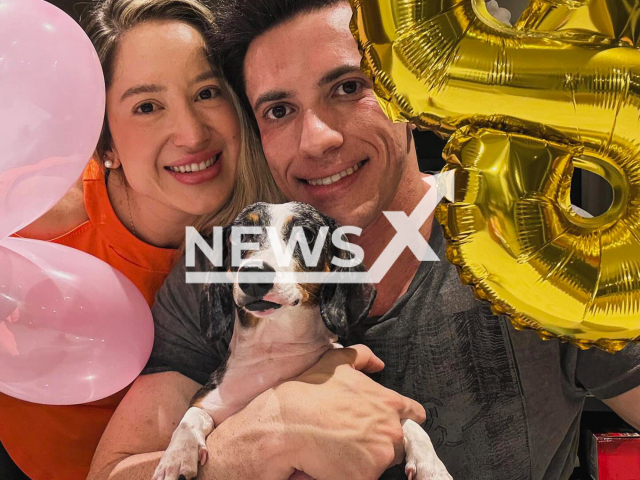 Professor Larissa Rodrigues poses with husband and their dog Pandora in undated photo. She died in Ribeirao Preto, Brazil. Note: Private photo taken from social media. (Newsflash/NX)