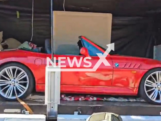 This image is a screen grab of the video supplied titled NewsX-SmugBeemer-01.mp4: Footage shows officers discovering a luxury BMW in the middle of a moving truck from the city of Posadas to the Buenos Aires neighborhood of Villa Luro, Argentina on Friday, May 2, 2025.(Clipzilla/NX)