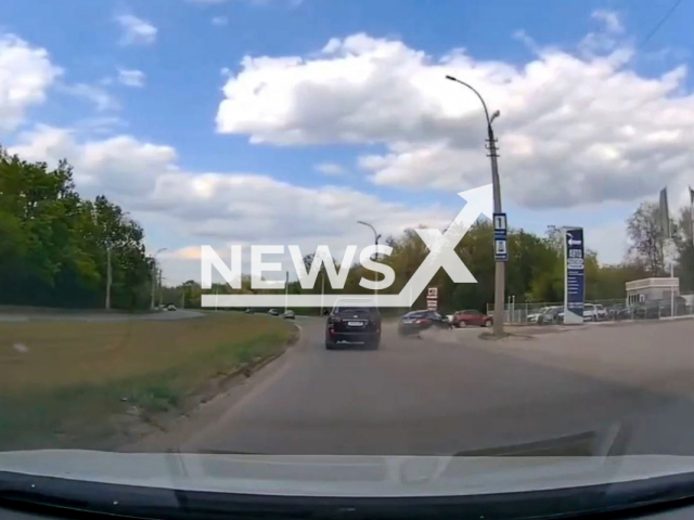This image is a screen grab of the video supplied titled NewsX-FastCarControl-01.mp4: Dashcam footage shows a fast-moving car losing control and crashing into parked vehicles in Lugansk, Ukraine, on Thursday, May 1, 2025.(Clipzilla/NX)