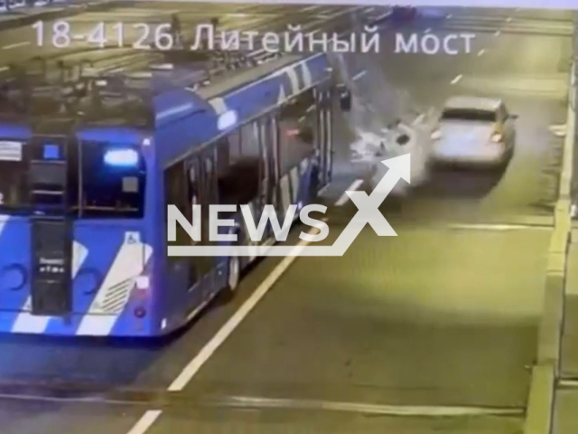 This image is a screen grab of the video supplied titled NewsX-RoadWorkerHit-01.mp4: CCTV footage shows a worker carrying buckets being struck by a car overtaking a bus on Liteiny Bridge in Saint Petersburg, Russia on Saturday, May 10, 2025.(Clipzilla/NX)