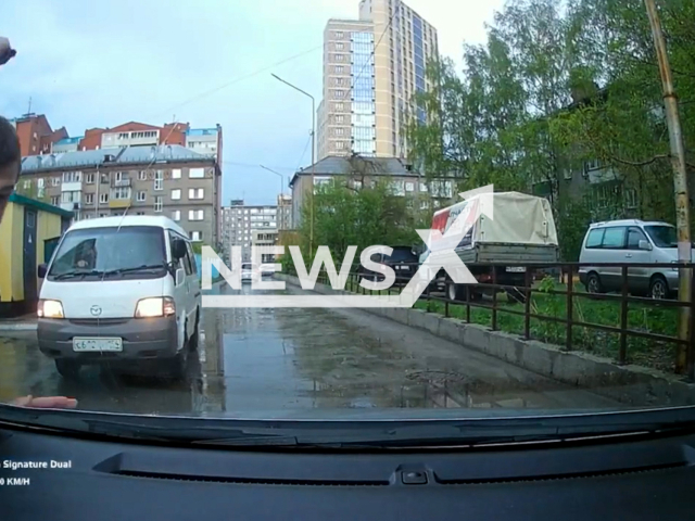 This image is a screen grab of the video supplied titled NewsX-RoadDispute-01.mp4: A man with a knife attacked a car driver, cut him and smashed the victim's car with a cobblestone in Novosibirsk, Russia on Saturday, May 10, 2025.(Clipzilla/NX)