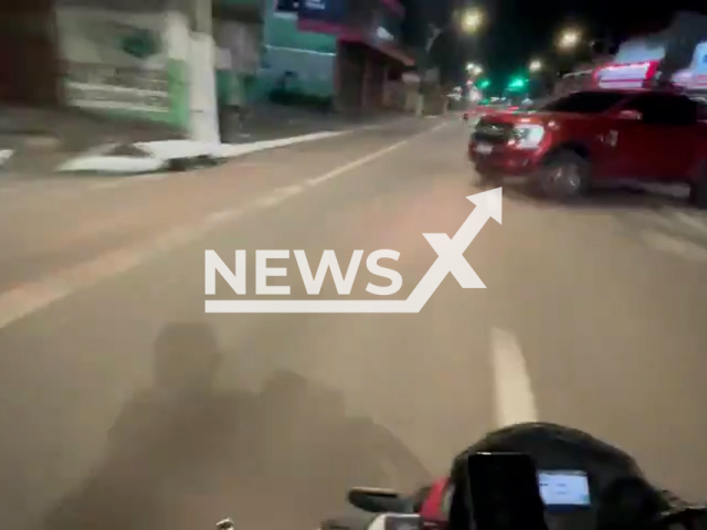 This image is a screen grab of the video supplied titled NewsX-DeshBike-01.mp4: A speeding motorcyclist collides with a pickup truck on Pedro Alvares Cabral Avenue in Belem, Brazil on Thursday, May 8, 2025.(Clipzilla/NX)