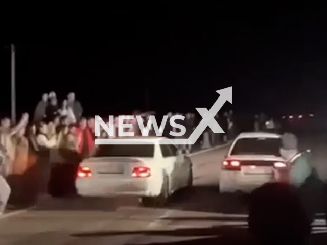 This image is a screen grab of the video supplied titled NewsX-IllegalRace-01.mp4: Footage shows a car veering off course and plowing into a crowd during an illegal street race in Angarsk, Irkutsk Region, Russia on Saturday, May 10, 2025.(Clipzilla/NX)