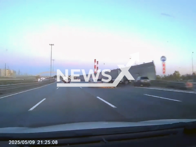 This image is a screen grab of the video supplied titled NewsX-CarSharingHit-01.mp4: A Volga with a trailer crashed into a car and a motorcycle parked on the Ring Road in Saint Petersburg, Russia, on Friday, May 9, 2025.( Clipzilla/NX)