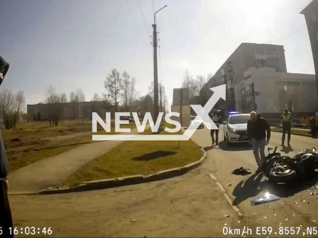 This image is a screen grab of the video supplied titled NewsX-FleePolCrash-01.mp4: Biker crashes into vehicle while fleeing police in Nizhnyaya Tura, Russia on Saturday, May 10, 2025.(Clipzilla/NX)