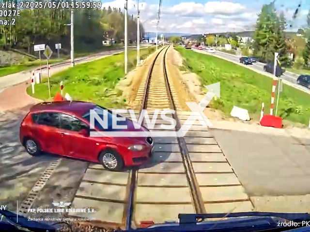 This image is a screen grab of the video supplied titled NewsX-TrainCross-01.mp4: CCTV shows a train hitting a car attempting to cross the tracks in Poronin, Poland on Thursday, May 1, 2025.(@PolskieLinieKolejowe/Clipzilla/NX)