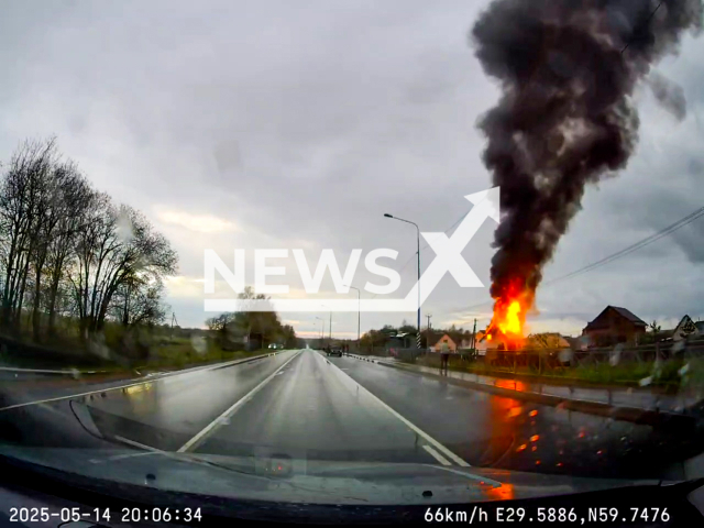 This image is a screen grab of the video supplied titled NewsX-BlazeHouse-01.mp4: Dashcam footage shows a massive blaze that destroyed the house was visible from miles away in Gostilitsy, Leningrad Oblast, Russia on Wednesday, May 14, 2025.