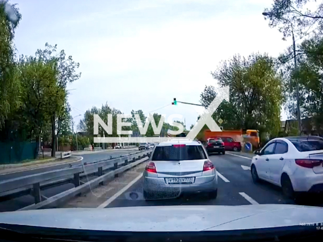 This image is a screen grab of the video supplied titled NewsX-TruckControll-01.mp4: Dashcam shows a truck driver driving down a hill, flying through a red light, and knocking out a minibus in Oznobishino, Vladimir Oblast, Russia on Saturday, May 17, 2025.(Clipzilla/NX)